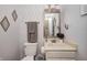 Cozy powder room with decorative mirror, sink, and patterned wallpaper at 1831 Whisperwood Trl, Danville, IN 46122