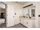 Double sink bathroom with granite counters, modern lighting, and a large mirror at 1831 Whisperwood Trl, Danville, IN 46122