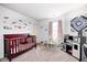 bedroom with crib, play area, and colorful wall decals at 1831 Whisperwood Trl, Danville, IN 46122