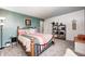 Inviting bedroom with decorative bed, teal accent wall, and natural light at 1831 Whisperwood Trl, Danville, IN 46122