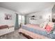 Charming bedroom features a cozy bed with vibrant quilt, blue curtains, and natural light at 1831 Whisperwood Trl, Danville, IN 46122