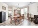 Open dining area with wood table, chairs, and views into an adjacent living room at 1831 Whisperwood Trl, Danville, IN 46122