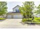 Beautiful home with a three-car garage, large driveway, and a well-kept front yard at 1831 Whisperwood Trl, Danville, IN 46122