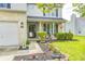 Inviting home exterior with a well-manicured lawn, charming front porch and attached two-car garage at 1831 Whisperwood Trl, Danville, IN 46122