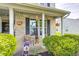 Charming front porch with cozy seating and hanging flower baskets, enhancing curb appeal at 1831 Whisperwood Trl, Danville, IN 46122