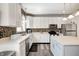 Bright kitchen features white cabinets, stainless appliances, and a stylish backsplash at 1831 Whisperwood Trl, Danville, IN 46122