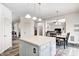 Open-concept view of the kitchen island, dining area, and living space at 1831 Whisperwood Trl, Danville, IN 46122
