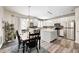 Bright eat-in kitchen with stainless appliances, light wood floors, and white cabinets at 1831 Whisperwood Trl, Danville, IN 46122