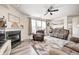 Bright living room with a cozy fireplace, plush seating, and ample natural light at 1831 Whisperwood Trl, Danville, IN 46122