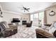 Spacious living room featuring comfortable seating, a fireplace, and large windows at 1831 Whisperwood Trl, Danville, IN 46122
