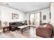 Cozy living room with two sofas, natural light from large windows, and neutral-toned walls at 1831 Whisperwood Trl, Danville, IN 46122