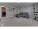 Relaxing basement area with carpet and a gray couch at 192 Bluestem Ln, Whiteland, IN 46184