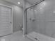 Modern bathroom featuring a glass-enclosed shower and neutral tile at 192 Bluestem Ln, Whiteland, IN 46184