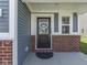 Inviting front porch with stylish door and brick accents at 192 Bluestem Ln, Whiteland, IN 46184