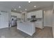 Bright kitchen features white cabinets, stainless appliances, and granite countertops with central island at 192 Bluestem Ln, Whiteland, IN 46184