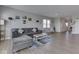 Open-concept living room featuring a large sectional couch, wood floors, and plenty of natural light at 192 Bluestem Ln, Whiteland, IN 46184