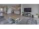 Open living room view showcases the living room flowing into the kitchen with stainless appliances at 192 Bluestem Ln, Whiteland, IN 46184