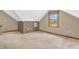 Finished attic space with carpeted floors, neutral paint, and a window for natural light at 1934 Constitution St, Greenfield, IN 46140