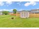 Backyard storage shed with a well-maintained lawn and privacy fence at 1934 Constitution St, Greenfield, IN 46140