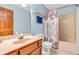 Bathroom featuring a shower with a floral shower curtain, a toilet, and a single sink vanity at 1934 Constitution St, Greenfield, IN 46140