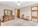 Neutral bedroom featuring a vintage dresser with a mirror and a partially visible walk-in closet at 1934 Constitution St, Greenfield, IN 46140