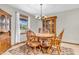 Traditional dining room featuring a round wooden table, matching chairs, and a glass front cabinet at 1934 Constitution St, Greenfield, IN 46140