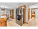 Open kitchen and dining area featuring a black stainless steel refrigerator and hardwood dining set at 1934 Constitution St, Greenfield, IN 46140