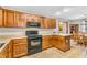 Kitchen featuring black appliances, warm wood cabinets, and laminate countertops at 1934 Constitution St, Greenfield, IN 46140