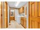 Well-lit laundry room with washer, dryer, and cabinets; adjacent to a bathroom with vanity at 1934 Constitution St, Greenfield, IN 46140