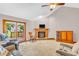 Comfortable living room with a brick fireplace, vaulted ceiling, and sliding glass door to the outdoor deck at 1934 Constitution St, Greenfield, IN 46140