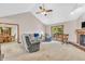 Spacious living room with neutral carpet, brick fireplace, and sliding door access to the back deck at 1934 Constitution St, Greenfield, IN 46140