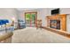 Bright living room with a cozy brick fireplace and sliding glass doors leading to an outdoor deck at 1934 Constitution St, Greenfield, IN 46140
