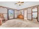 Bright main bedroom with a large window, vintage wallpaper, and convenient access to the closet and ensuite at 1934 Constitution St, Greenfield, IN 46140