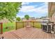 Wooden deck with an outdoor grill and seating area, ideal for relaxing at 1934 Constitution St, Greenfield, IN 46140