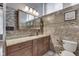 A stylish bathroom with tiled walls, granite vanity, and a decorative mirror at 196 E Madison St, Franklin, IN 46131