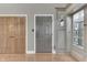 Stylish entryway featuring a gray door, wood floors, and a decorative mirror, creating a warm and inviting space at 196 E Madison St, Franklin, IN 46131