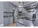 Modern kitchen featuring stainless steel appliances, granite countertops, and stylish gray cabinetry at 196 E Madison St, Franklin, IN 46131
