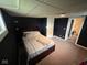 Finished basement bedroom with dark blue walls, carpeted floor, and egress window at 209 N Lincoln St, Martinsville, IN 46151