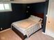 Finished basement bedroom with dark blue walls, carpeted floor, and egress window at 209 N Lincoln St, Martinsville, IN 46151