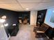 Finished basement office space with carpeted floors, desk and shelving at 209 N Lincoln St, Martinsville, IN 46151