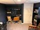 Finished basement office space with carpeted floors, desk and shelving at 209 N Lincoln St, Martinsville, IN 46151