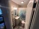 Updated bathroom with modern vanity, decorative mirror, and shower/tub combination at 209 N Lincoln St, Martinsville, IN 46151