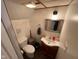 Cozy bathroom featuring a toilet, vanity with sink, mirror, and modern fixtures at 209 N Lincoln St, Martinsville, IN 46151