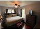 Comfortable bedroom featuring hardwood floors, ceiling fan, dresser and natural light from windows at 209 N Lincoln St, Martinsville, IN 46151