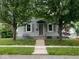 Charming gray two-story home with a well-manicured lawn and mature trees at 209 N Lincoln St, Martinsville, IN 46151
