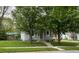 Charming home with mature trees and well-maintained lawn enhance curb appeal and create a welcoming atmosphere at 209 N Lincoln St, Martinsville, IN 46151