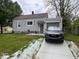 Well-maintained single-story home featuring an attached garage and neatly landscaped front yard at 209 N Lincoln St, Martinsville, IN 46151