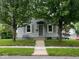 Charming single-story home with a well-manicured lawn and inviting front porch with a seating area at 209 N Lincoln St, Martinsville, IN 46151
