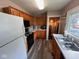 Functional kitchen with wood cabinets, laminate countertops, and a range of appliances at 209 N Lincoln St, Martinsville, IN 46151