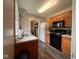 Functional kitchen with wood cabinets, laminate countertops, and a range of appliances at 209 N Lincoln St, Martinsville, IN 46151